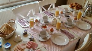 洛芬德赫姆甜梦住宿加早餐酒店的桌上放有盘子、鸡蛋和蜡烛
