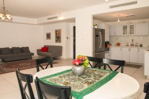 耶路撒冷Luxurious Huge 5R in Jerusalem center的厨房以及带桌椅的起居室。