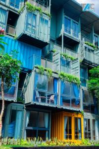 Buôn Kô SirAmacon Hotel & Coffee的公寓大楼设有色彩缤纷的阳台和植物