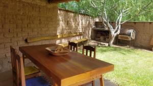 蒂尔卡拉La Casa de los Molles的后院的木桌和椅子,配有烧烤架