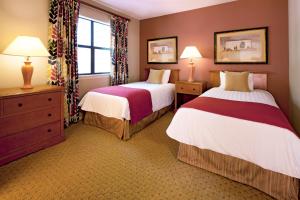 Fairfield BayClub Wyndham Resort at Fairfield Bay的酒店客房设有两张床和窗户。