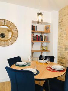 卡朗唐Le Salon de l'Isle的一间带木桌和椅子的用餐室