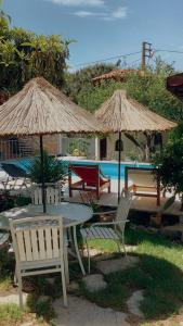 贝尔加马阿克罗波利斯酒店的游泳池畔的桌椅和遮阳伞