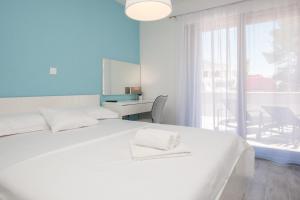 波尔Apartments Dva Galeba的白色的卧室设有白色的床和窗户。