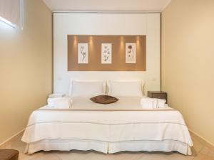 多穆斯德马里亚Giglio di Chia - Your Dream Holiday的一间卧室配有一张带白色床单的大床