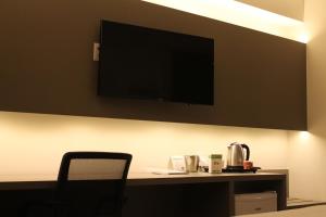 戈亚尼亚Holiday Inn - Goiania, an IHG Hotel的一间设有一张桌子的房间,墙上有一台电视机
