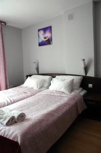 米科瓦伊基Słoneczne Tarasy的一间卧室配有一张床,上面有两条毛巾