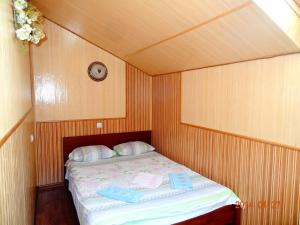 Solonka伯格玛汽车旅馆的一张小床,位于一个小房间里,配有时钟