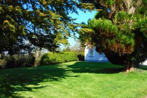 利默里克Sporting Lodge Shanagolden的一座有白色房子、树木和草地的院子