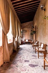 圣安那托利亚迪纳Ex Convento Santa Croce-Country resort的大楼内带桌椅的房间