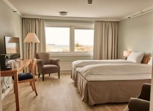 索拉索拉海滨酒店的配有一张床、一张书桌和一扇窗户的酒店客房