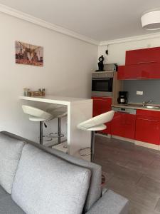 汉诺威Apartment Martinstraße 7b的厨房配有红色橱柜和灰色沙发