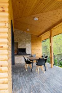 韦林格勒Villa Dea & Villa Ina - Villas & SPA Park in Velingrad的木制庭院的甲板上配有桌椅