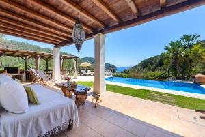 卡拉圣维森特Villa Can Sans的享有带一张床和游泳池的别墅的外部景色
