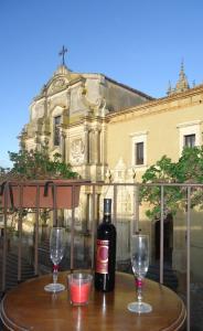 卡尔塔吉罗Gualtiero Camere & Suite的一张桌子上放着一瓶葡萄酒,放上两杯