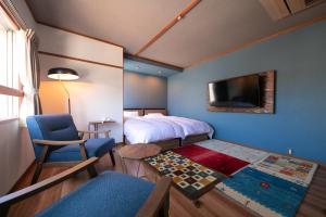 别府国东庄旅馆的一间卧室配有一张床、一把椅子和电视。