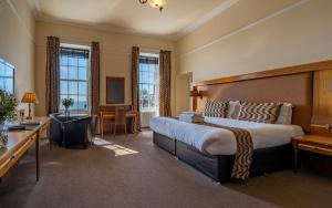 安斯特拉瑟白可酒店的酒店客房设有一张大床和一台电视。