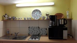 普特布斯Ferienwohnung Putbus的厨房配有水槽、咖啡设施和冰箱
