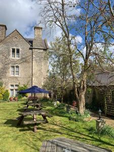 比斯特Littlebury Hotel的大楼前的野餐桌和雨伞