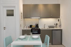 瓦西Antheon apartments的厨房配有桌椅和台面