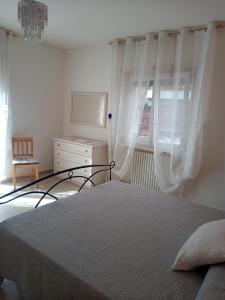 科皮托Nel cuore di Coppito的一间卧室配有一张床、一个梳妆台和一扇窗户。