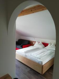 泰尔拉诺Pension Runer的一间卧室设有一张大床和拱门