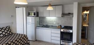 圣卡洛斯-德巴里洛切Bariloche Modern Apartment的厨房配有冰箱和炉灶。 顶部烤箱