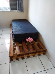 圣保罗Apartamento Beira Mar - Vila Guilhermina的木平台上的一张床铺,上面有植物