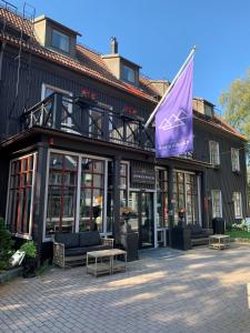 奥勒阿若格登酒店的前面有紫色旗帜的建筑