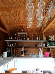 特罗佩阿Afrodite Accomodation的厨房设有木墙和带玻璃杯的台面