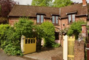 曼海德Minehead mews cottage的砖屋前的黄色门