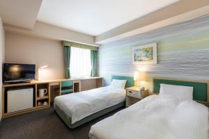 札幌商务北酒店的酒店客房设有两张床和一台平面电视。
