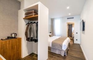 赫罗纳半岛酒店的酒店客房设有一张床和一个衣柜。