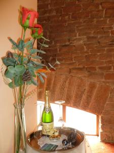 彭里斯THE GINNEY Country Guest House的一张桌子,上面放着一瓶葡萄酒和花瓶