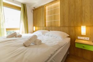 赫维兹La Bella Centrum Apartmanok Kék Zöld的一间卧室配有两张带白色枕头的床