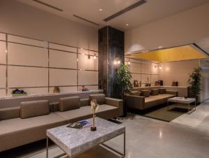 金泽HOTEL TORIFITO KANAZAWA的大厅配有沙发和桌子,位于客房内