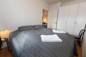阿克雷里Central Apartment with Two bedrooms and Balcony- Strandgata 9的一间卧室配有一张带白色毛巾的床