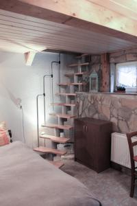安娜贝格-布赫霍尔茨Ferienhaus Oertel的卧室内拥有带螺旋楼梯的石墙