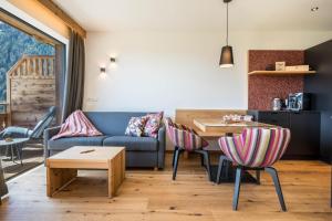 里约·迪·普斯特里亚App Mulin Loise mit Sauna的客厅配有沙发和桌椅