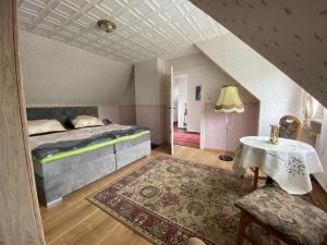 施维洛塞Ferienhaus Marianne的阁楼卧室配有1张床和1张桌子