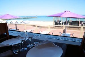 库尔瑟勒·苏尔·梅尔拉科瑞迈莱尔酒店的一张带眼镜的桌子,享有海滩美景