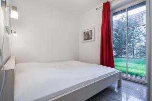 博尔滕哈根Strandvilla Niklot Wohnung 02的白色的卧室设有床和窗户