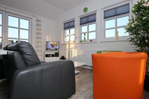海利根达姆Residenz von Flotow Wohnung 18的客厅配有真皮沙发和电视