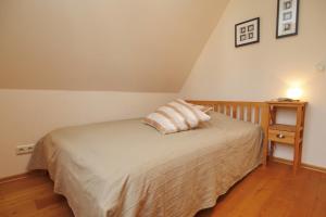 维滕贝克Ferienhaus Nanni的一间卧室配有一张床和一个带灯的床头柜