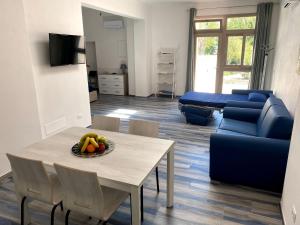 费拉约港Appartamenti Acquazzurra的客厅配有桌子和蓝色沙发