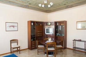 基奥贾Palazzo Baffo - Residenza storica , Chioggia的客厅配有桌椅和电视。