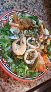 依索安Imsouane soul lodge的桌上一碗沙拉,上面有虾和蔬菜