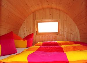 吕本瑙古肯法斯迷你酒店的木制客房内的一间卧室,配有一张床