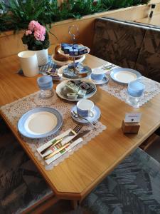 米尔施塔特祖姆穆尔拉德膳食公寓的一张木桌,上面有盘子和盘子