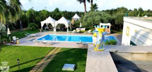 马里内拉Villa Sogno Charme E Relax的一座带房子的庭院内的游泳池